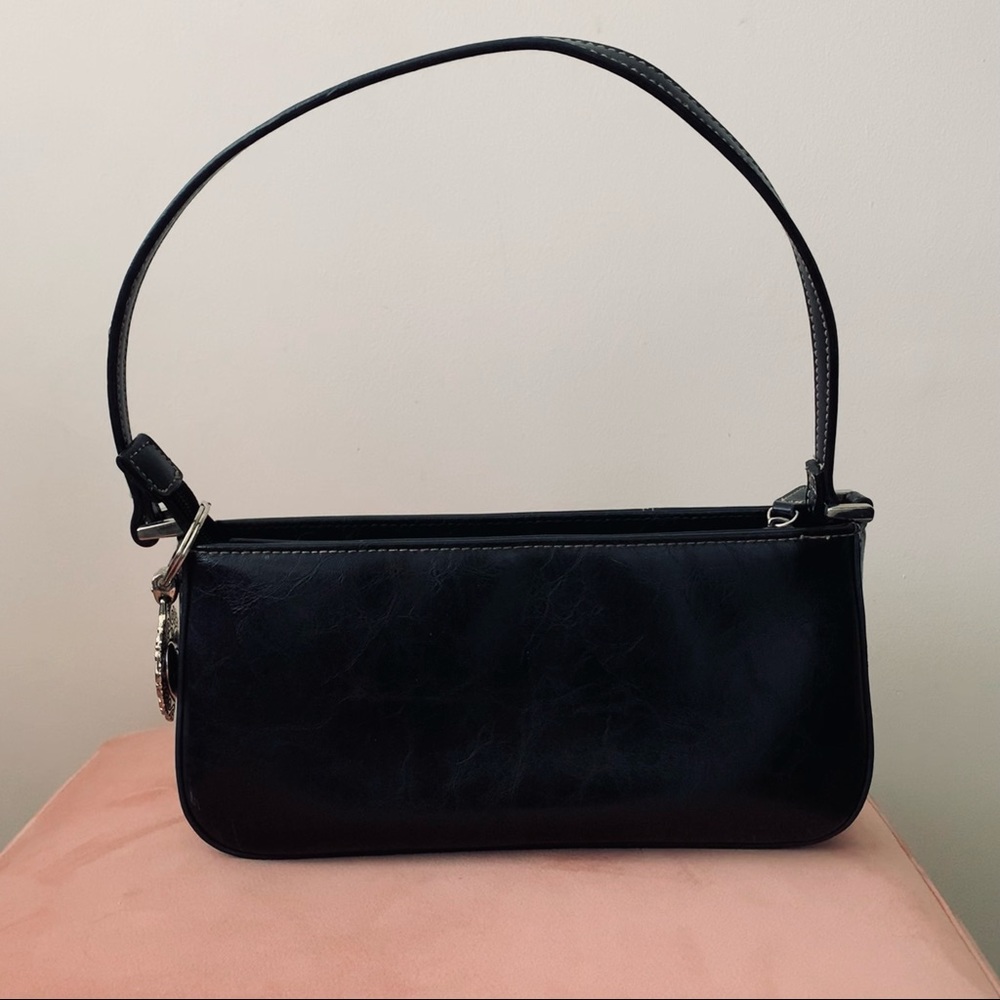 Beautiful black leather bag with elegant charm